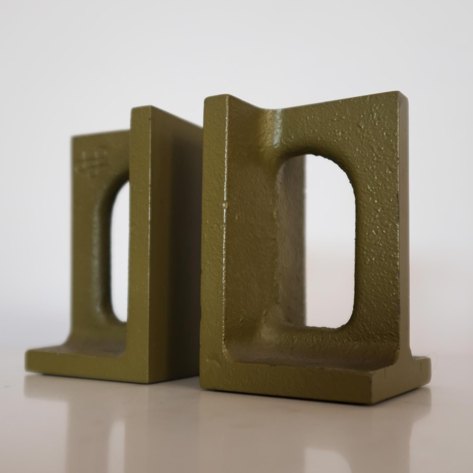 Bookends by Bill Curry for his Company, Design Line. Designed and manufactured in El Segundo, CA in the 1960s. Cast iron with green lacquer. The model is 