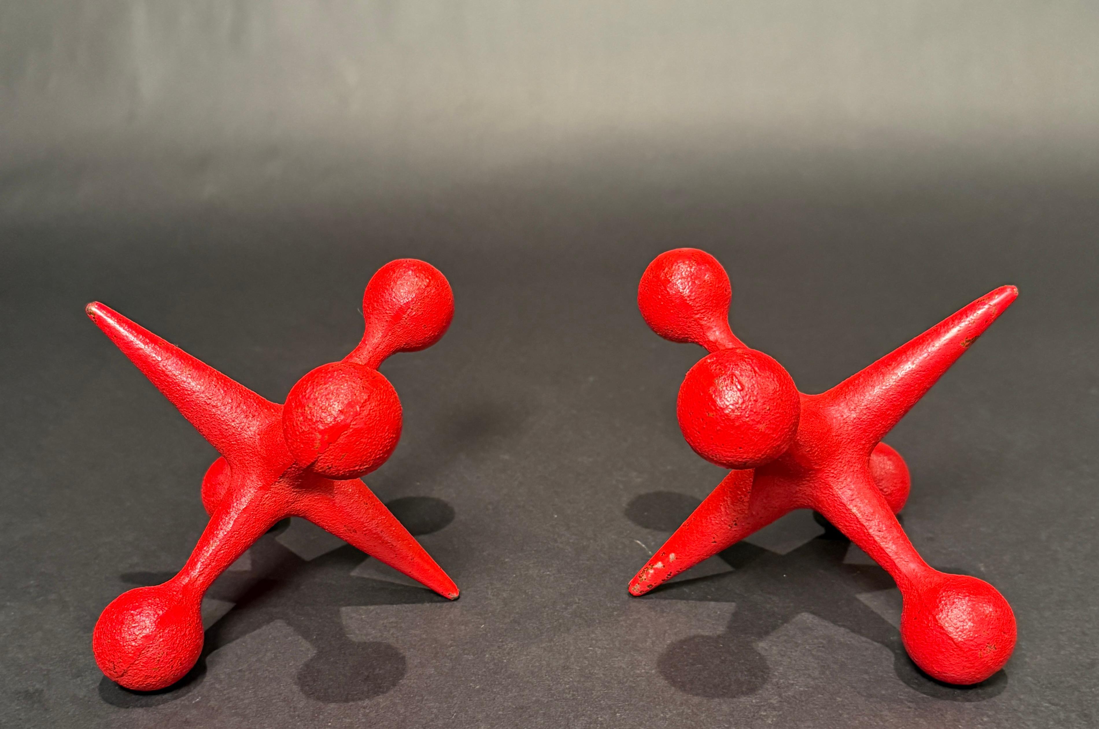 Pair of Bill Curry Jacks (Jax) bookends. These are truly mid century modern icons and vintage must haves. These are Design Line Model J-1 Jacks, made in California. They are cast iron in red, adding a great pop of color to any room. The clever jack
