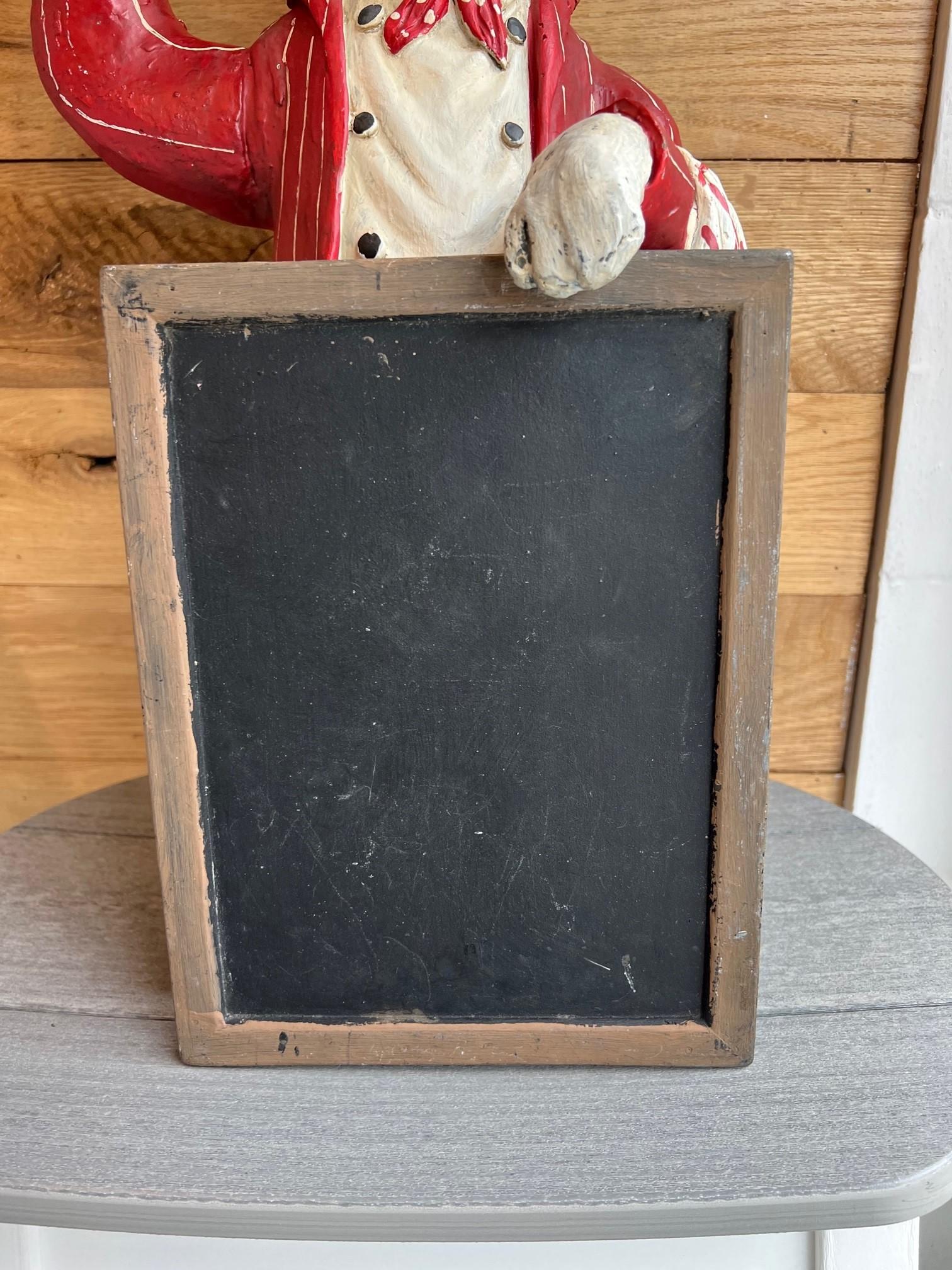 chef statue with chalkboard