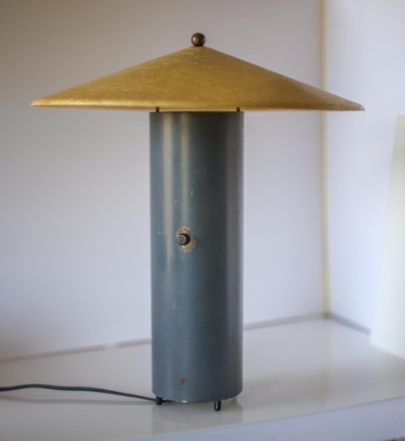 Table lamp composed of an enameled steel tube with a tiltable Fiberglas reflector shade, designed and produced by Asian/American designer and educator Bill Lam in 1952. William M.C. (Bill) Lam (1924-2012), a pioneer in architectural lighting, was