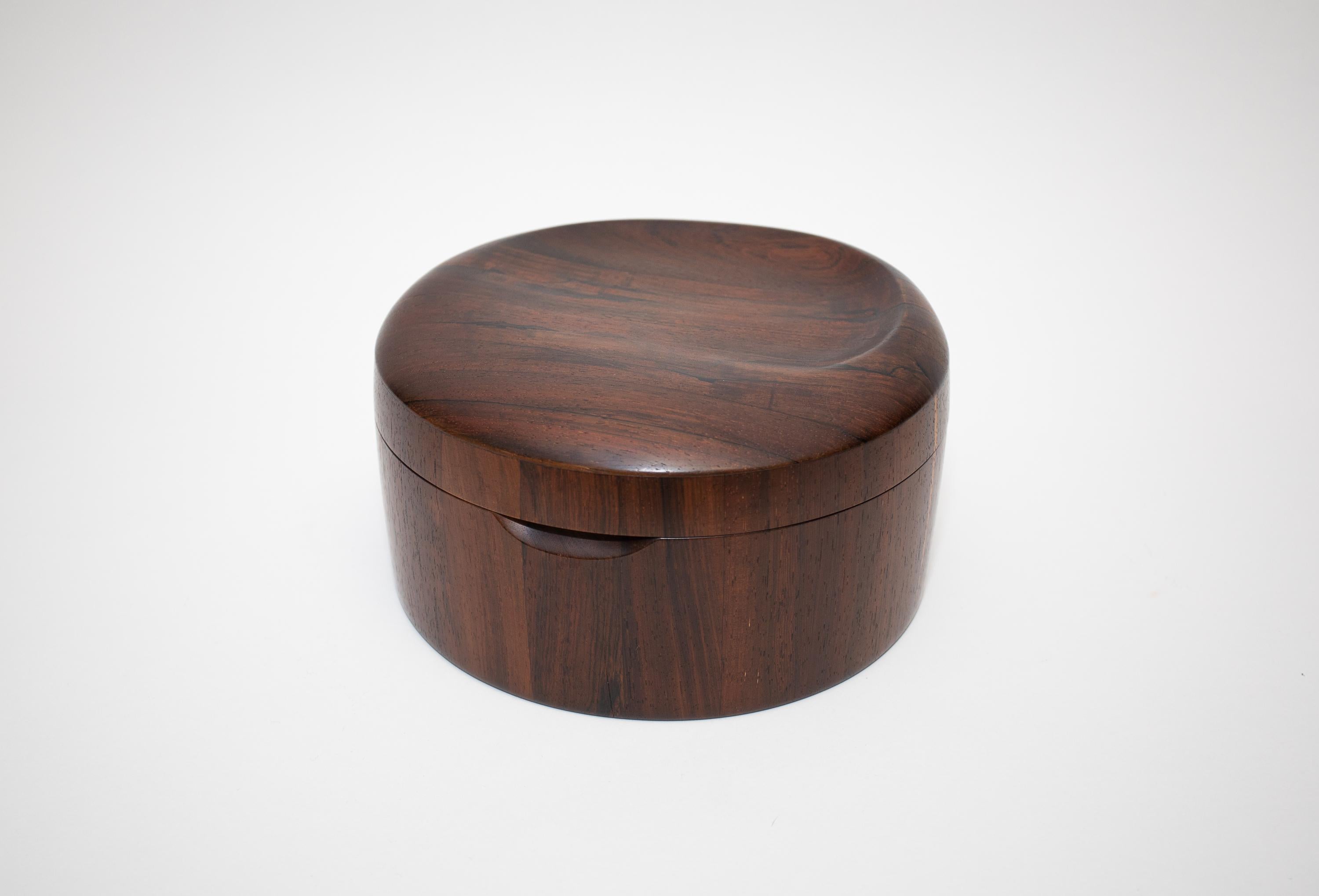 A Dark Rosewoo box with an integrated hand carved Tray.
Great wood grain and Organic Form. 
 