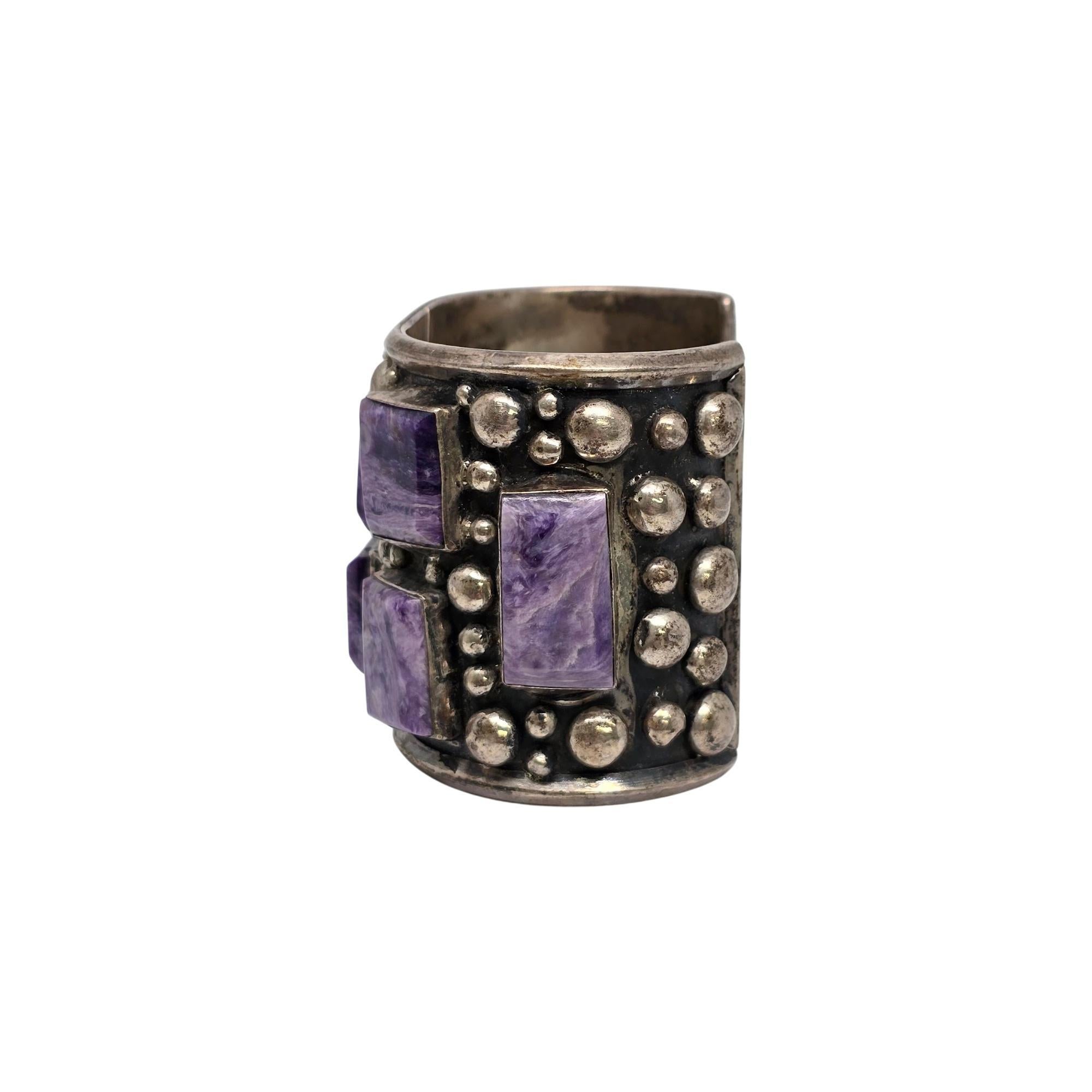 Sterling silver and charoite wide cuff bracelet by Mexican artisan Bill Mex Dineh'.

This is a large and substantial piece, featuring large bezel set purple charoite stones with silver ball beads all around the bracelet.

Measures approx 7 1/2