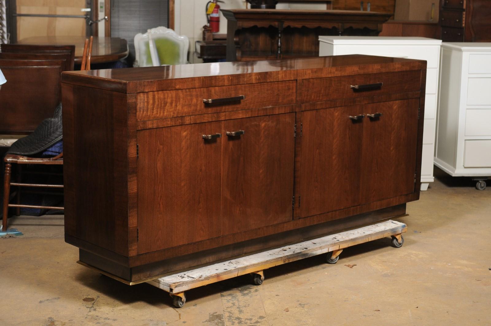Bill Sofield for Baker mahogany sideboard credenza. Features fine veneered accents with brushed brass hardware and base. Two drawers, one with fabric flatware protection and storage. Four-door with adjustable shelves. Dimensions: 37 X 84 X 21 in.