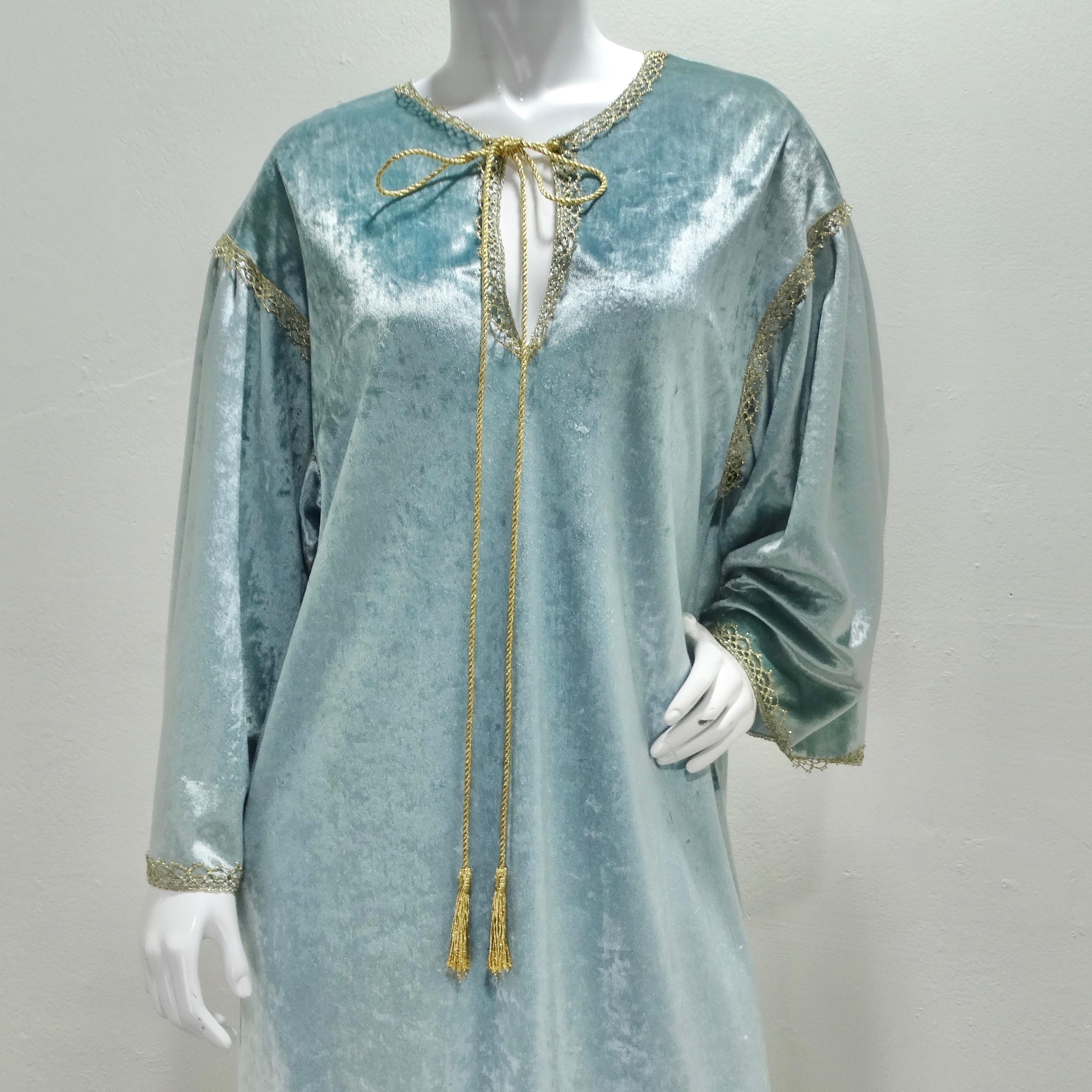 Indulge in luxurious comfort and timeless style with the Bill Tice 1980s Blue Velvet Kaftan. This exquisite kaftan style dress offers a cozy and relaxed fit, making it the epitome of effortless elegance. Crafted from a sumptuous light blue velvet