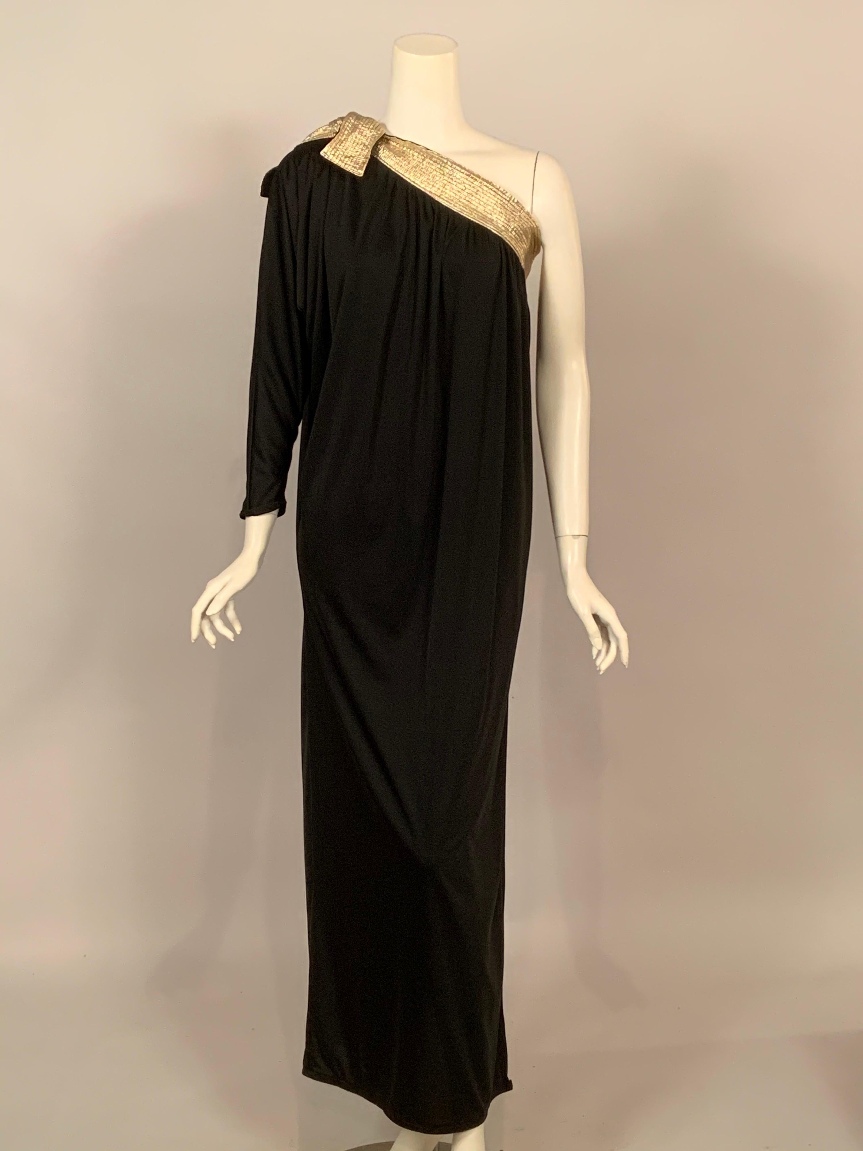 The elegance of an evening dress with the comfort of an at home outfit, Bill Tice designed both beautifully. This dress has a quilted band of metallic gold fabric at the bodice which ties above the single sleeve. The dress falls gently from this