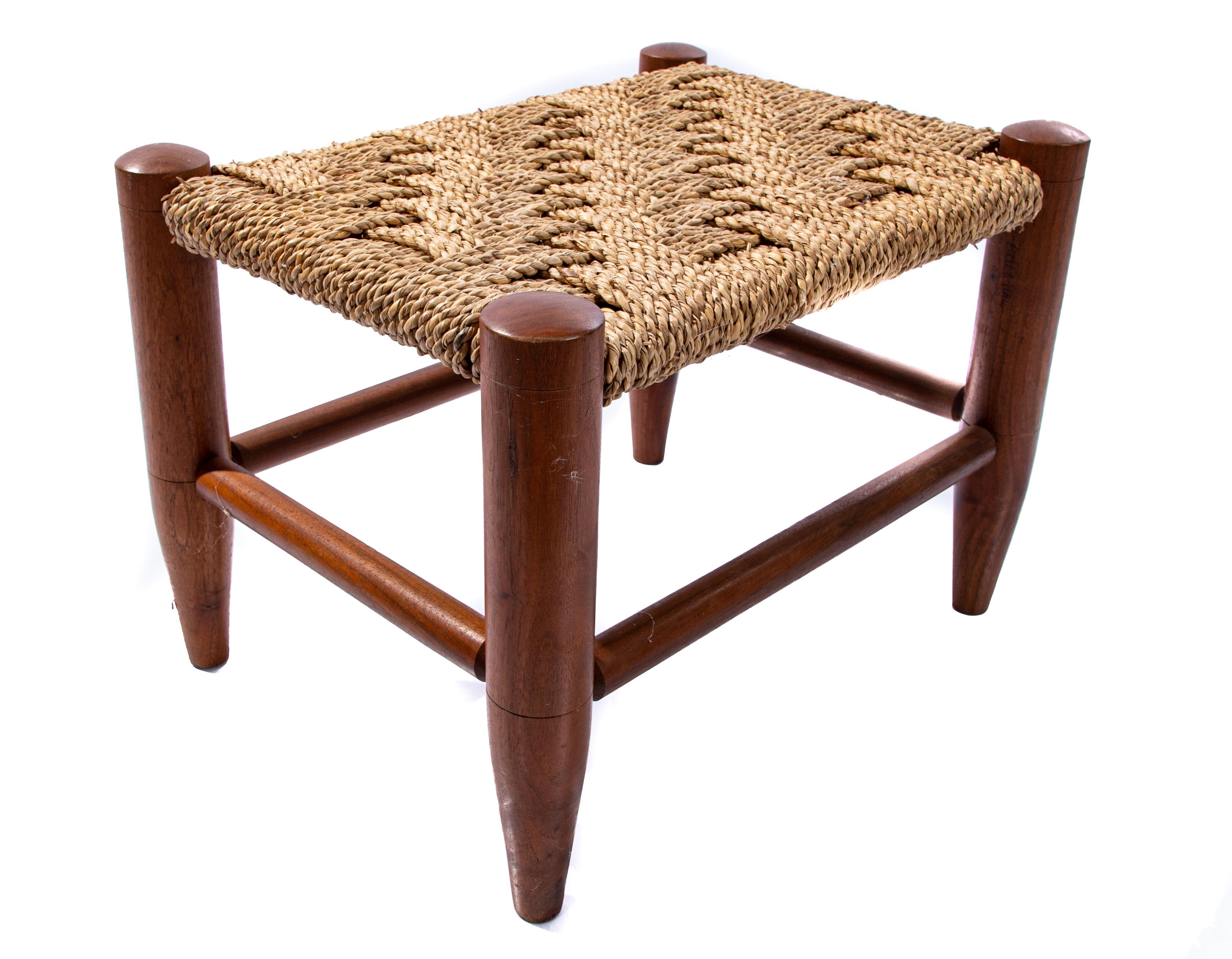 Offering a one of a kind foot stool by Bill Wilkey. Having simple turned legs and stretchers it has a midcentury feel. The top is a braided cane that is woven. It is signed on one of the legs by Bill Wilkey in 2004.