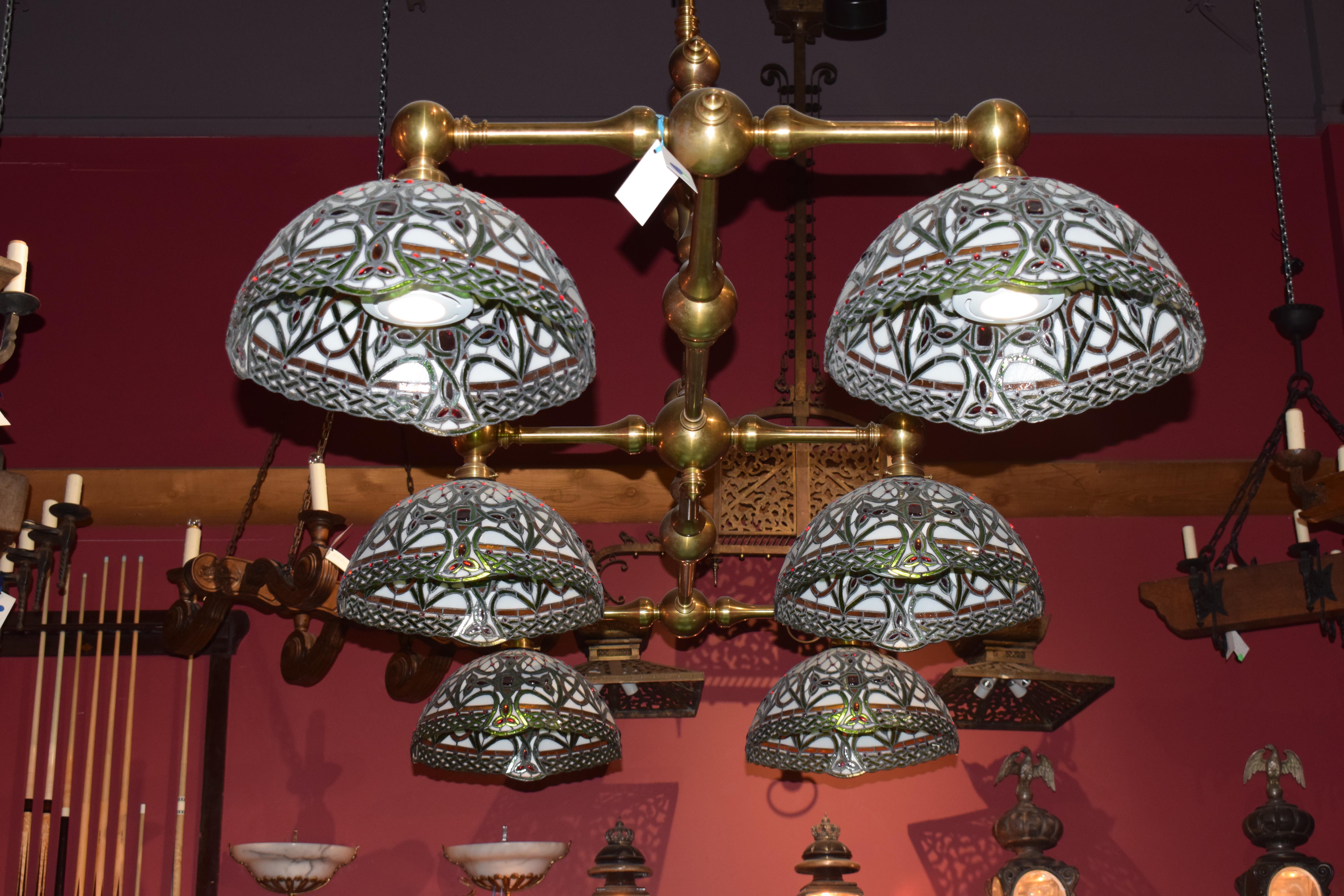 An Extraordinary Billiard Chandelier, having solid turned bronze frame and Tiffany style shades (the shades are of a later manufacture).
Dimensions: Height 75