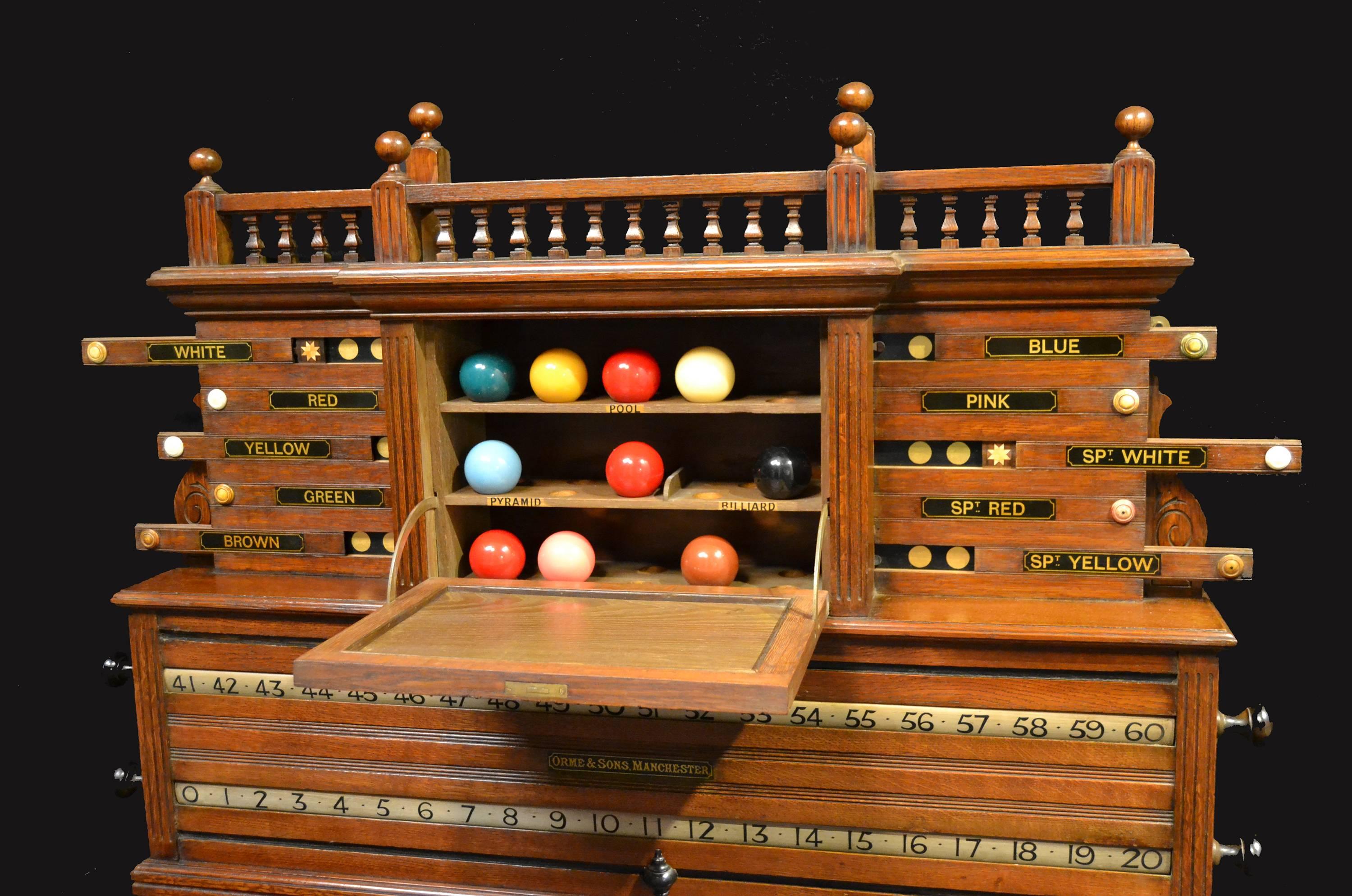 This wonderfully constructed Billiards scoring cabinet consists of revolving number bars, life pool sliders and a central slate section which opens to reveal a hidden ball storage compartment. Made by 