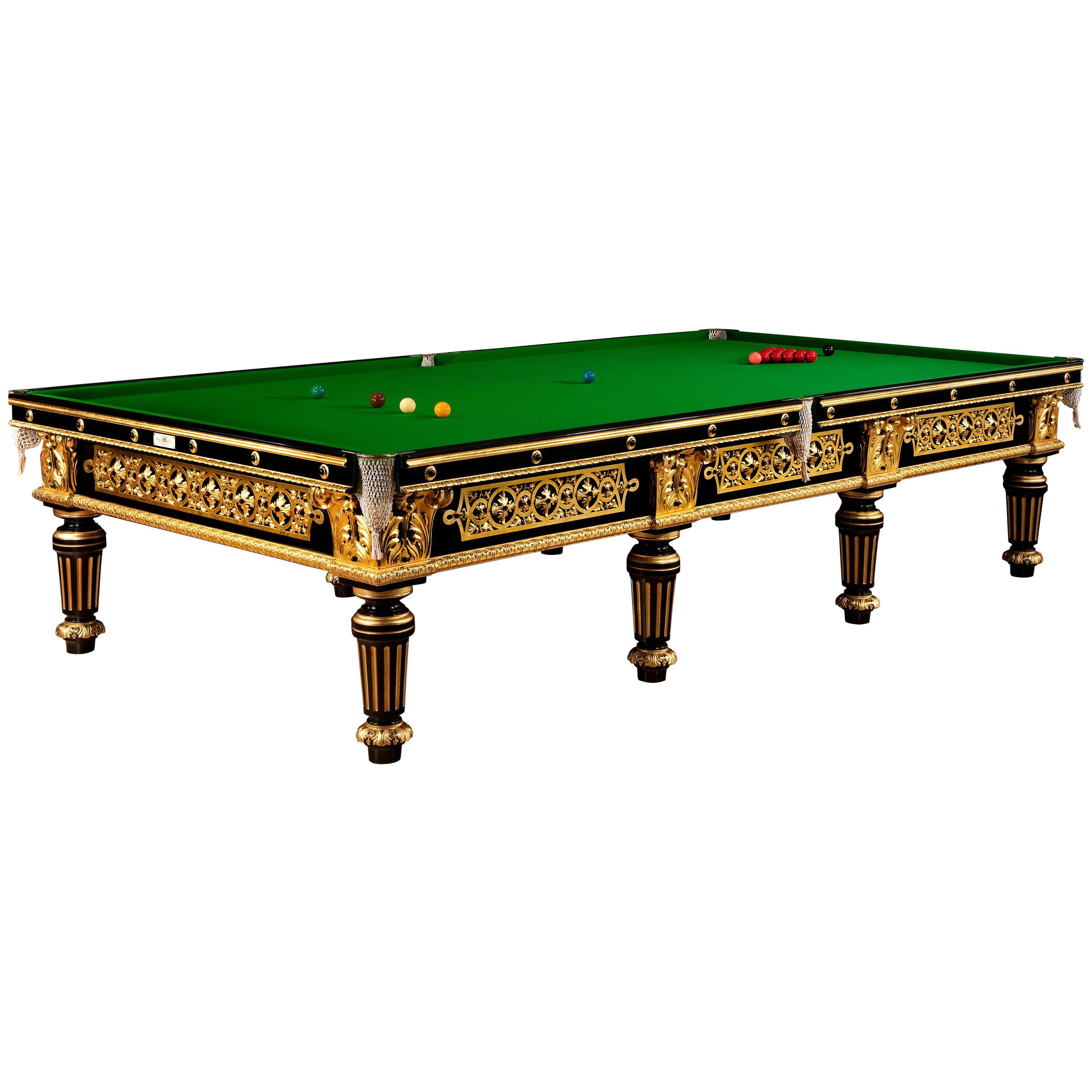 This striking full size (12ft) Billiard table was made for James Blyth, 1st Baron Blyth (1841-1925) for 33 Portland Place, London. It is veneered in ebony with openwork giltwood panels applied to the sides and boldly carved and gilded acanthus leaf