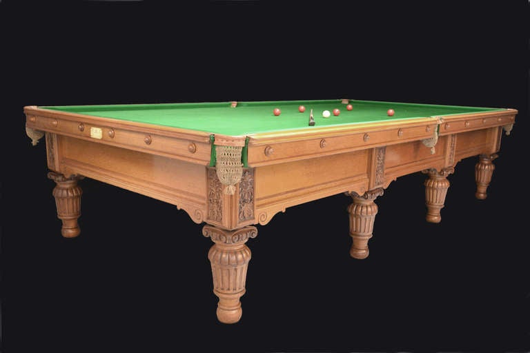 A carved oak 12ft x 6ft billiard, snooker or pool table by George Wright of London, circa 1885, standing on eight decorative fluted and gadrooned carved legs, topped with capital corbels.

The substantial side frame is complimented by scroll