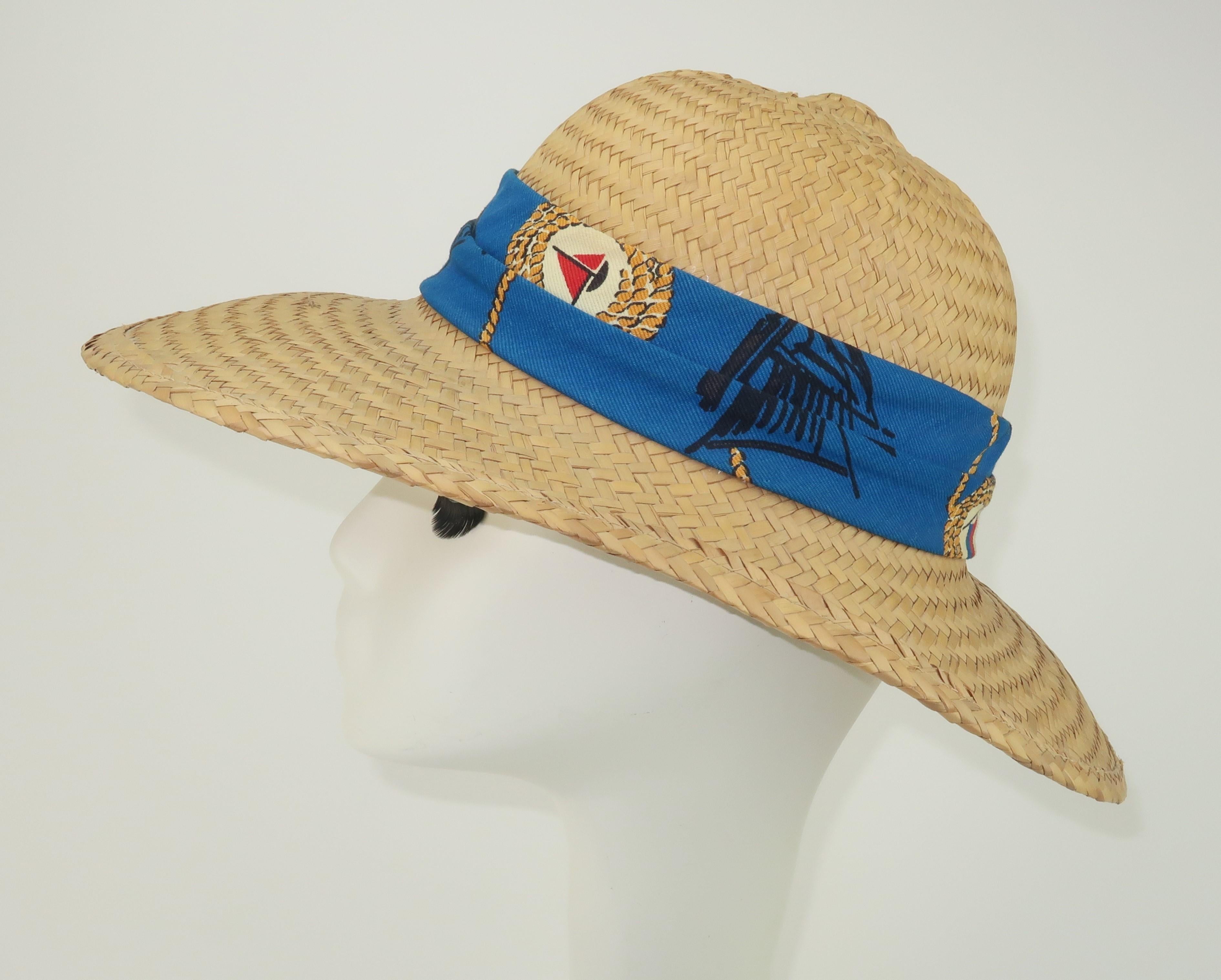 1960's Billie Ross of the Palm Beaches natural straw hat with a nautical band in shades of red, white, blue and golden yellow.  The body of the hat was made in Mexico and it has a unique elongated silhouette with pith helmet style details including