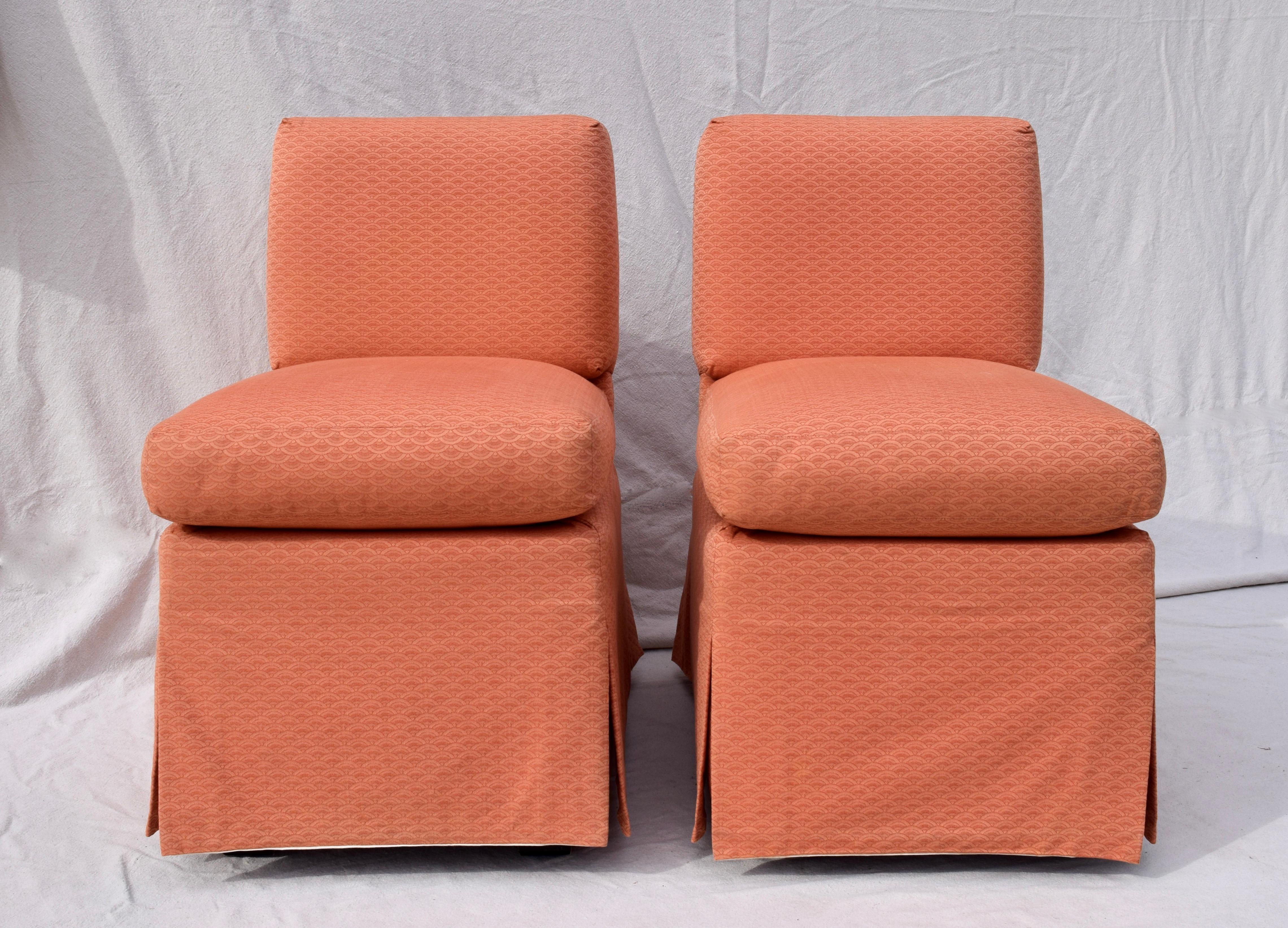 A pair of Billy Baldwin slipper chairs in original salmon upholstery. Unusual narrow design allows for versatile placement options with standard 19.5