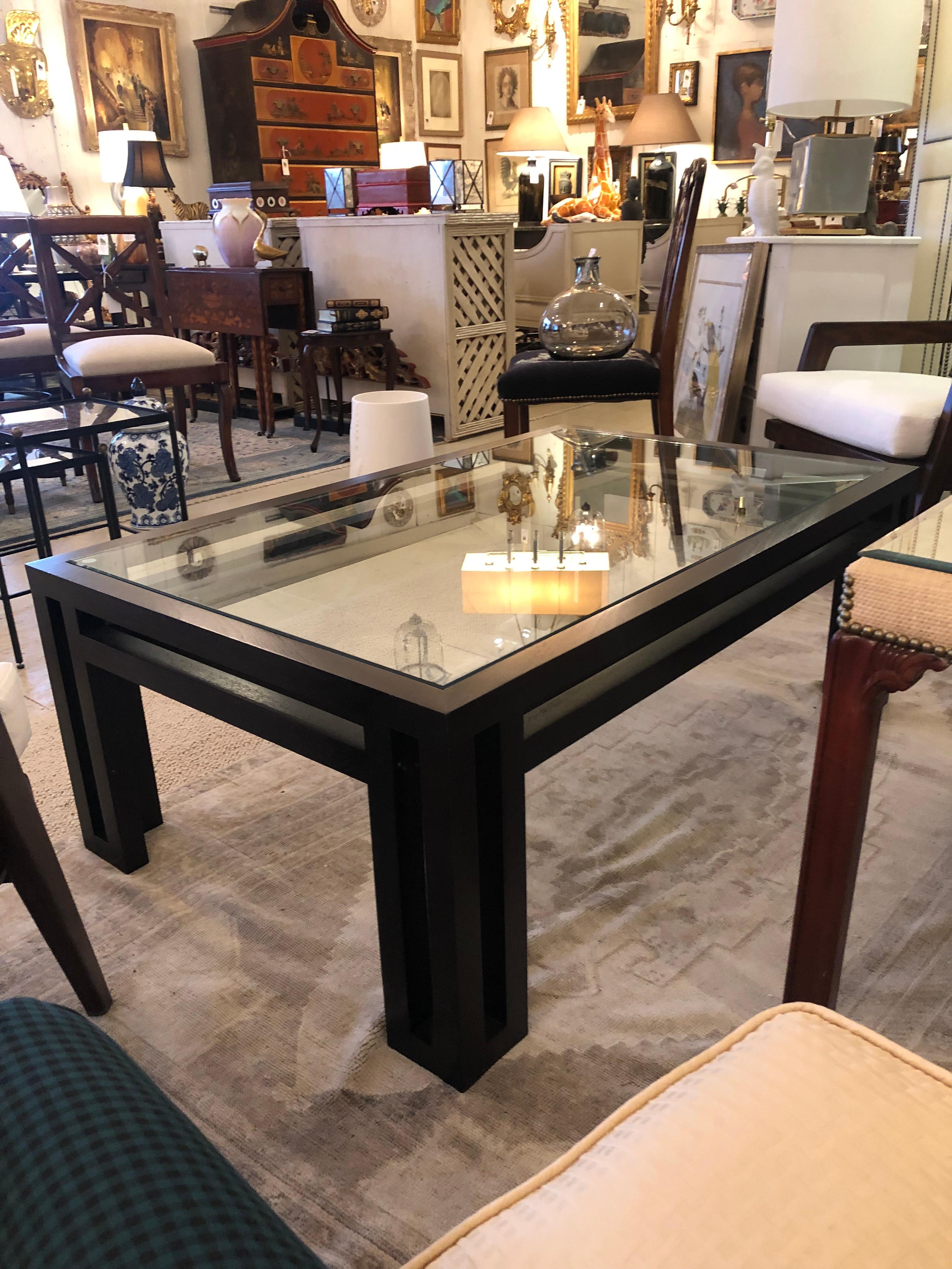 Super chic iconic designed ebonized wood and glass coffee table from the Billy Baldwin Collection.
