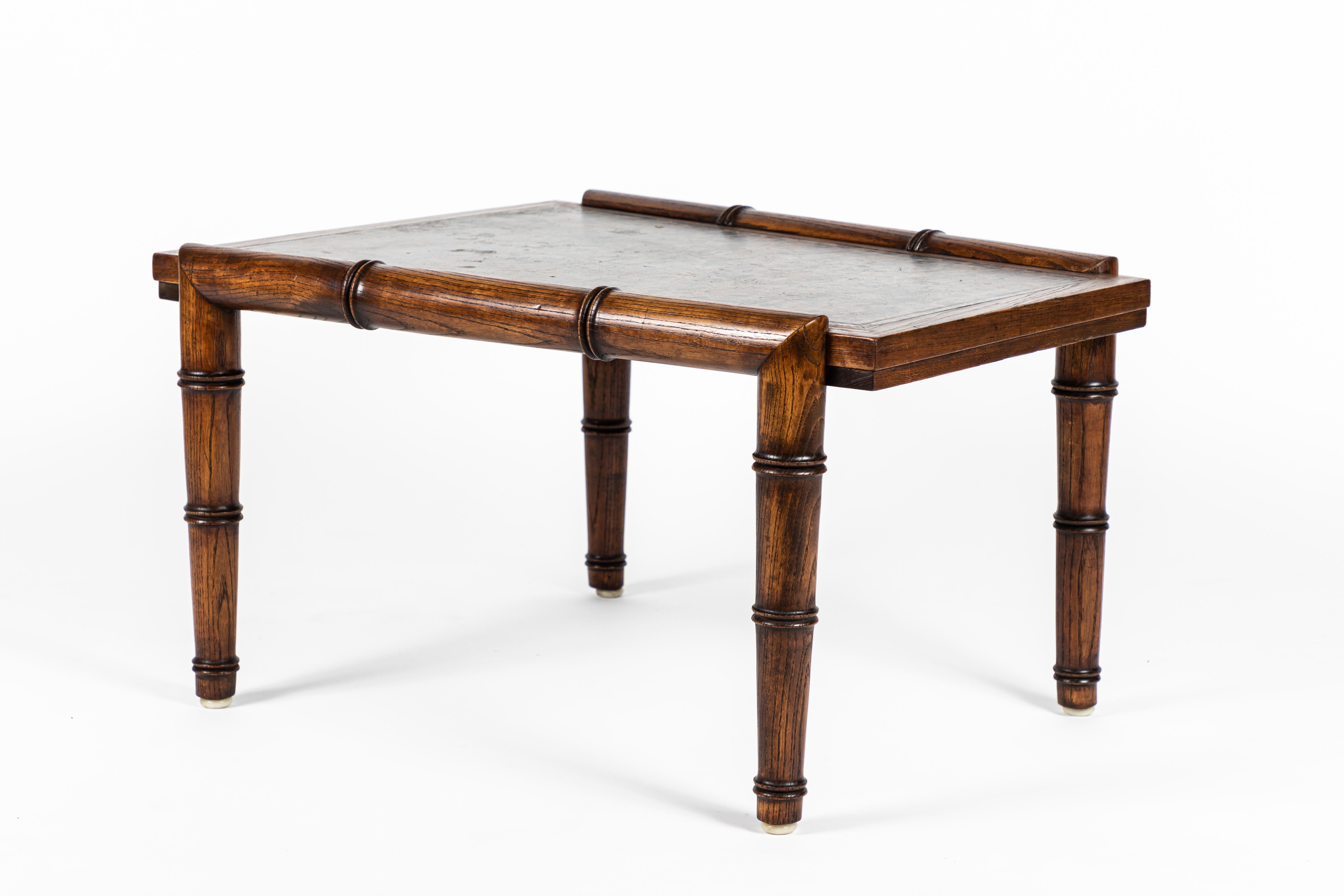 This table unique in its form includes 2 of Haines’ signature elements, faux bamboo and tortoise stained Leather. Originally designed for a Montecido estate it is in all original condition and in fine shape. The wood has been waxed and is original.