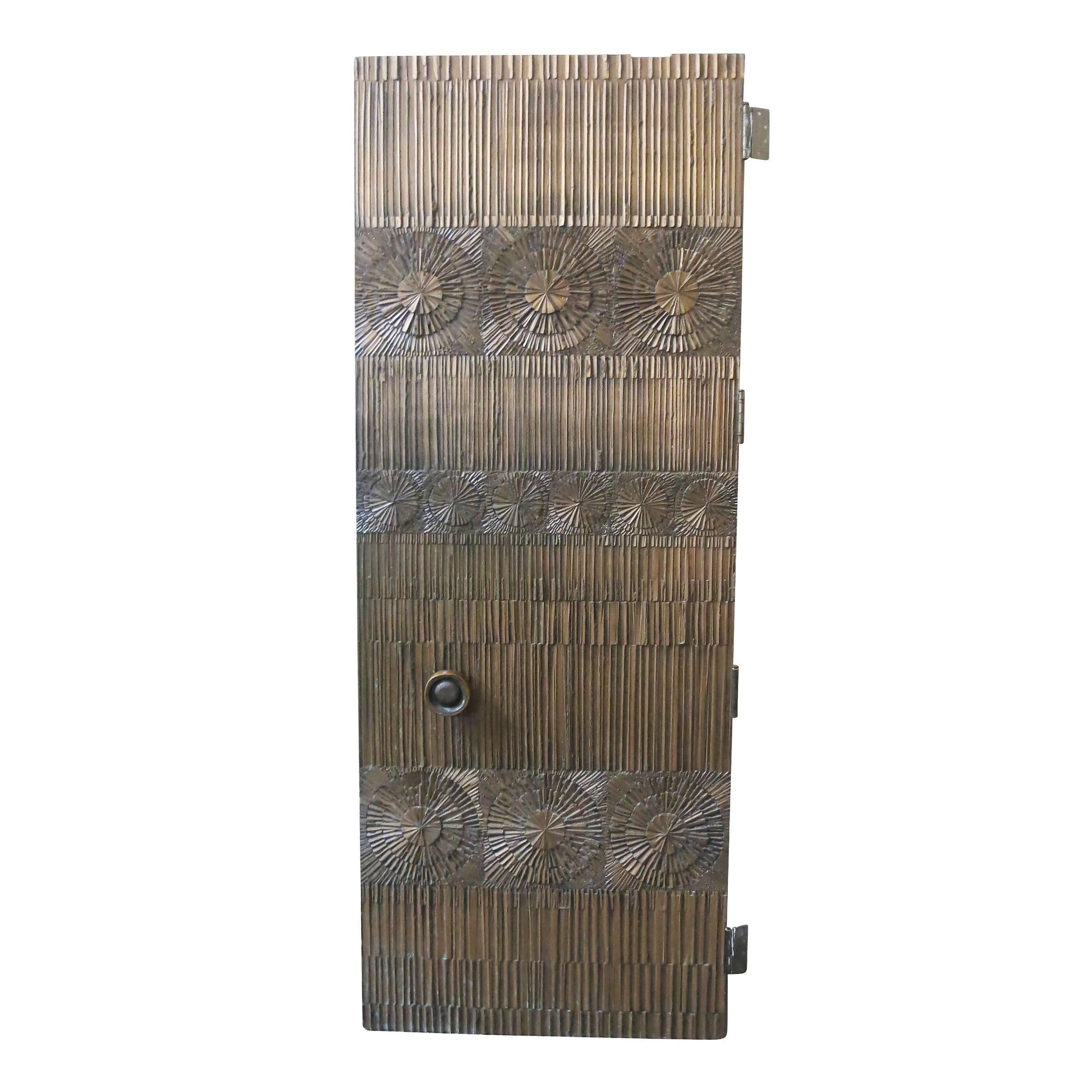 double sided Brutalist door designed by Billy Joe Mccarroll and David Gillespe and produced by Forms and Surfaces, Inc. in Santa Barbara, California.

This door, with mixed-media sculptural front, is made with a bonded metal technique in bronze