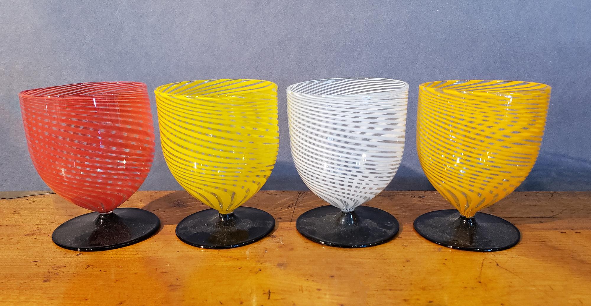Bimini Swirl Cordial Glasses,
Austria
Set of Four,
The 1920s-30s

The four Bimini glasses, with a black wide foot, each have a different colored swirl- yellow, orange blue, and white

Dimensions: 3 inches high x 2 1/4 diameter at the rim.
 