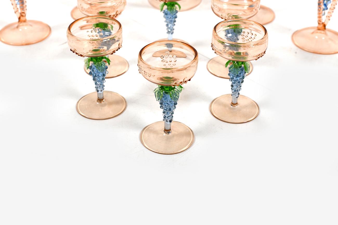 Decanter and 12 glasses by Bimini Werkstätten Wien 1920s-1930s. Decoration with grapes. In beautiful pastel colors. One glass with minimal chip.

Measures: Decanter H. 22.5 cm / W. 10.0 cm
Small glasses Height 8.5 cm / diameter 4.5 cm
Big