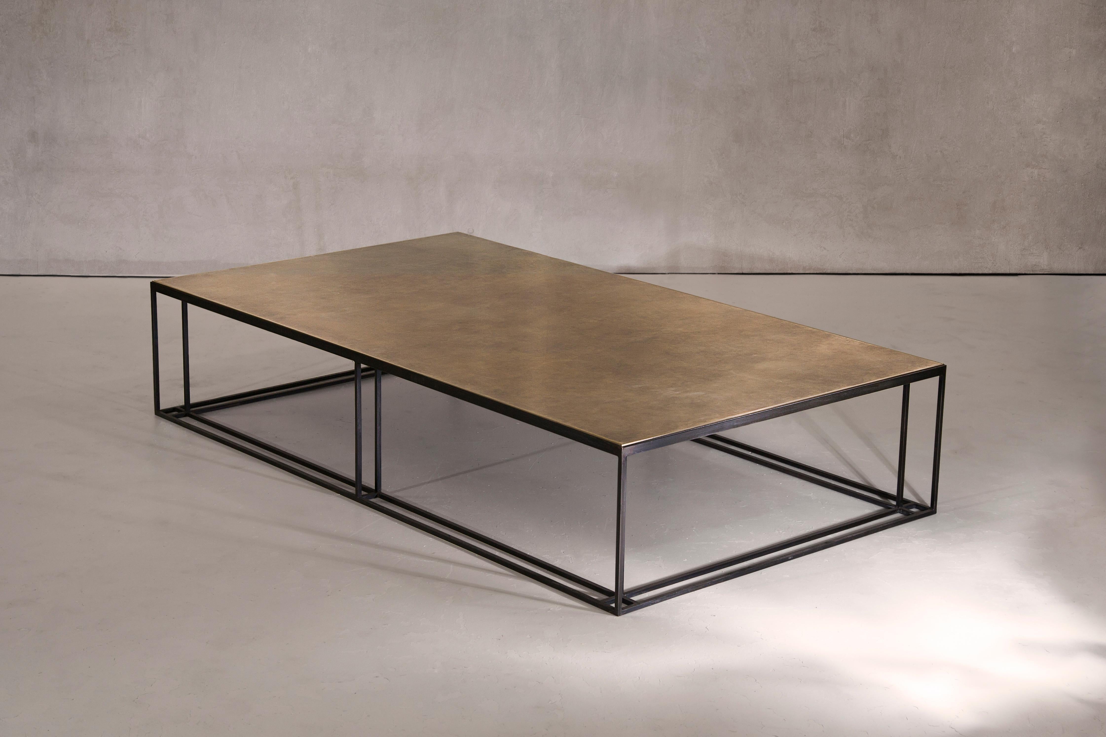 A coffee table in blackened steel and patinated brass, with a polished brass trim. Hand crafted to order in the North. Bespoke finishes and sizes are available.

Measures: 160cm width x 90cm depth x 35cm height.
Custom finishes and sizes