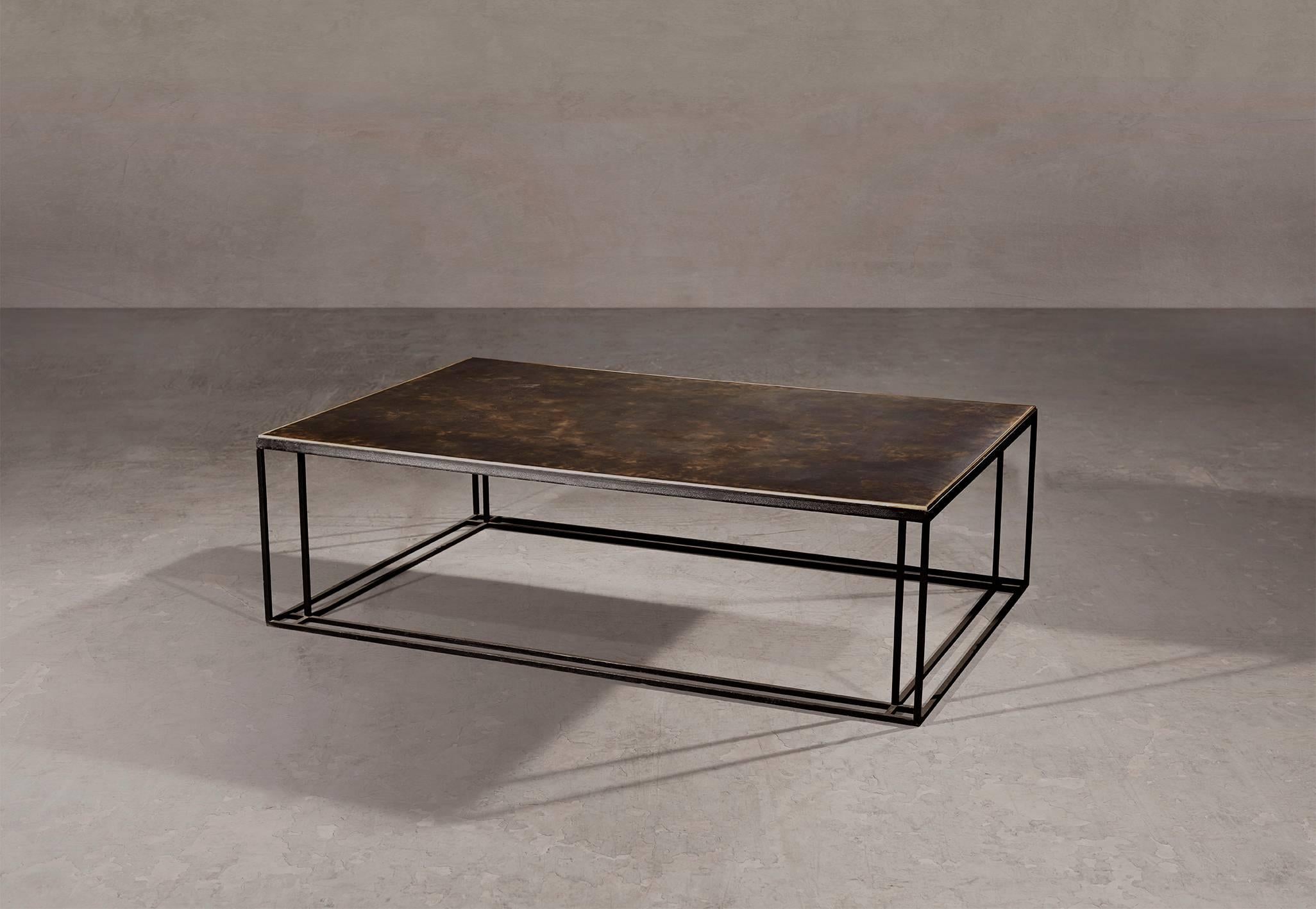 A coffee table in blackened steel and patinated brass, with a polished brass trim. Hand crafted to order in the North. Bespoke finishes and sizes are available.

Measures: 120cm width x 80cm depth x 35cm height.
Custom finishes and sizes