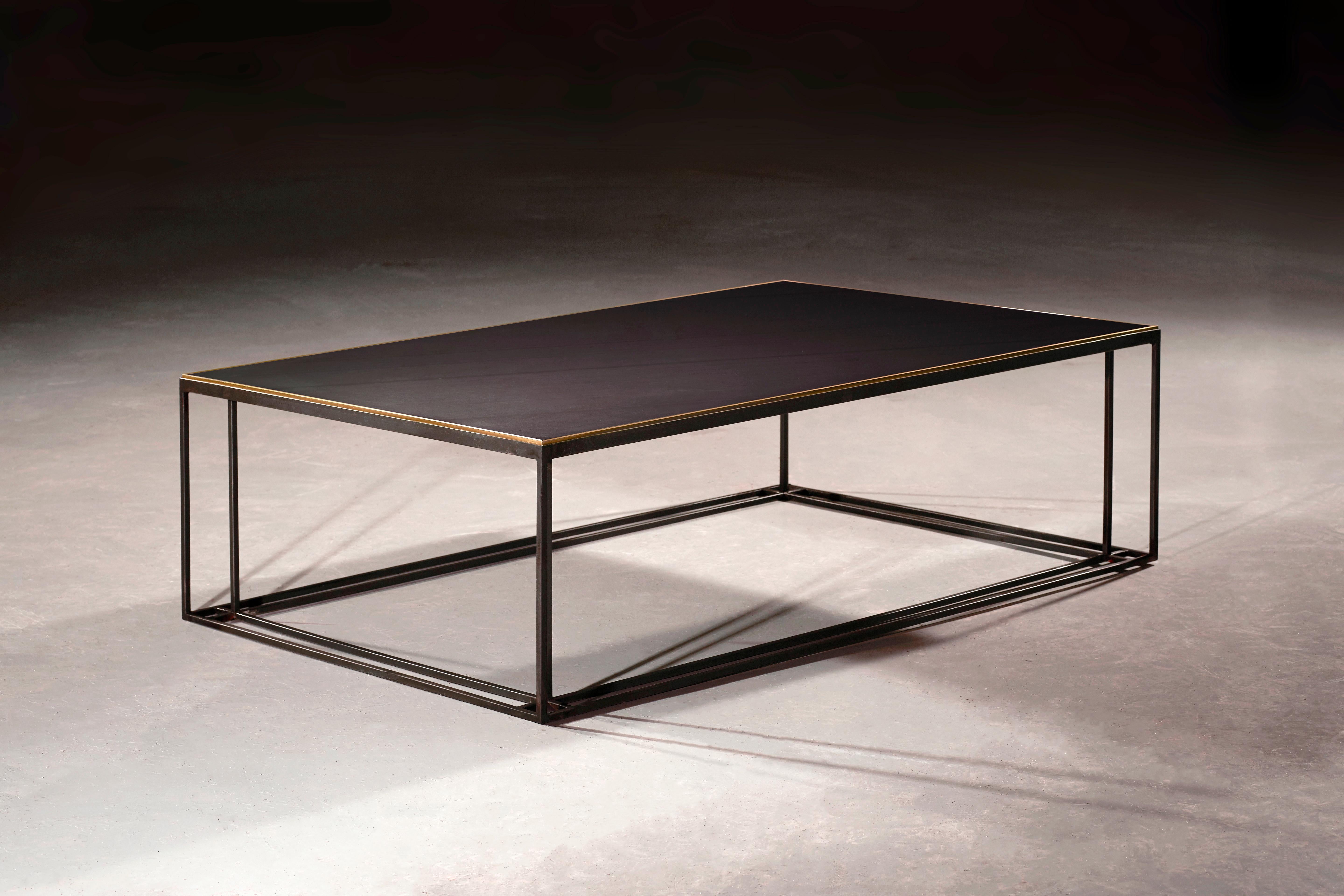 A coffee table in blackened steel and honed Cumbrian slate, with a polished brass trim. Hand crafted to order in the North. Bespoke finishes and sizes are available.

Measures: 90cm width x 60cm depth x 35cm height.
Custom finishes and sizes