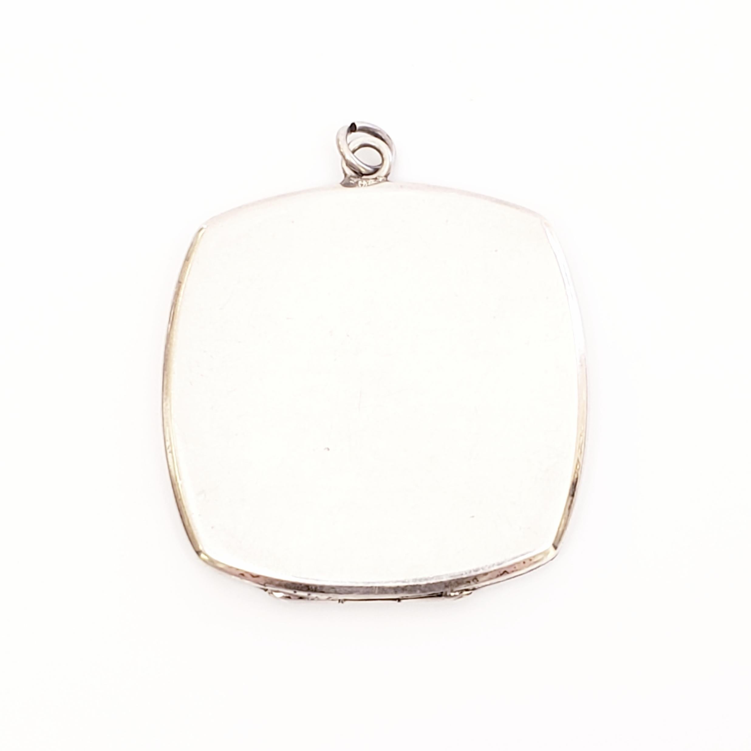 Vintage large square sterling silver locket by Binder Bros, Inc of NY, NY, circa 1910-1920.

Beautiful chased and respousse design in a floral and leaf motif.

Measures 1 5/8