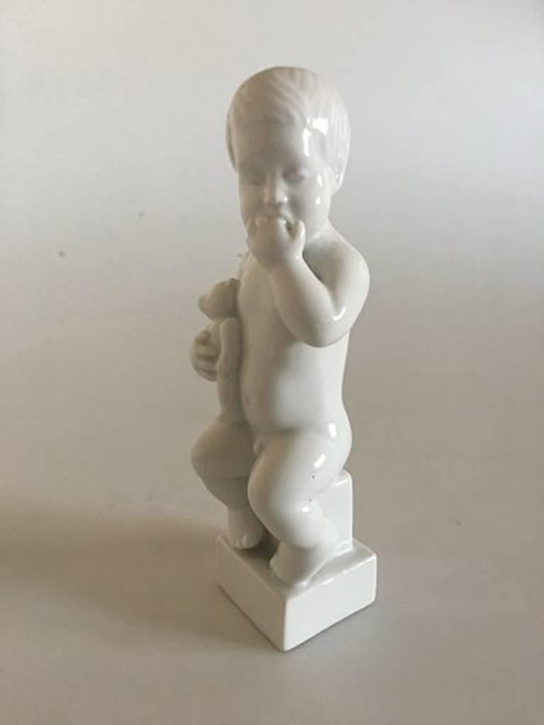Bing & Grondahl Blanc de Chine figurine of boy with teddy bear #2231. Modelled by Sv. Lindhardt. Measures: 16.5 cm H (6 1/2 inches).