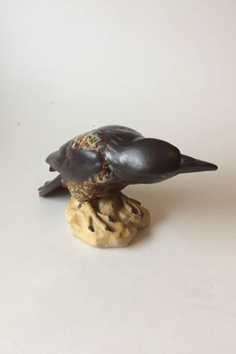Bing & Grondahl by Dahl Jensen stoneware figurine of crow #1714. Measures 17 x 31 cm / 6 11/16 inches x 12 13/64 inches.
