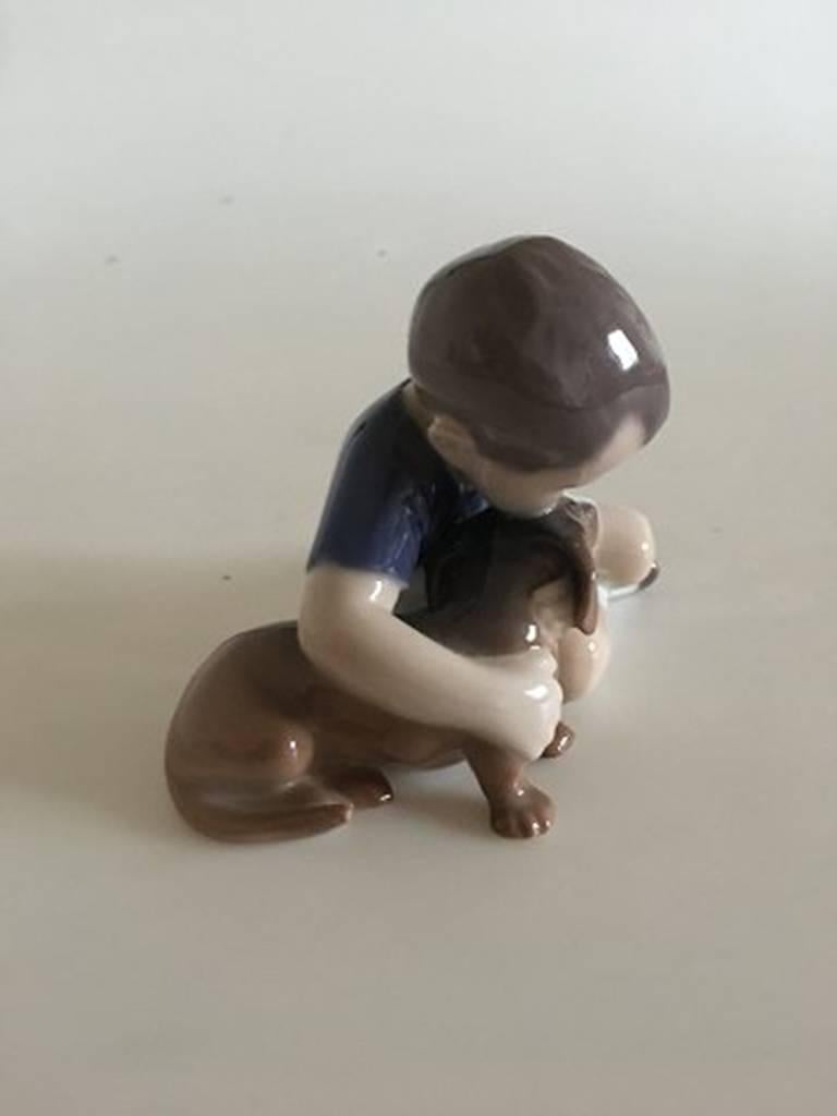 Bing & Grondahl figurine boy with dachshund #1951. Measures 13cm x 10cm and is in perfect condition.
