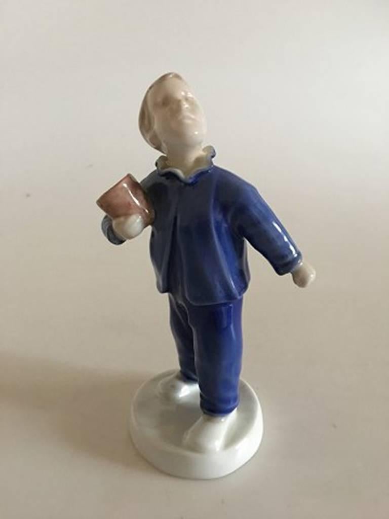 Bing & Grondahl figurine of boy with pot - Who is calling - #2251.

Measures: 15.5cm / 6 1/10 in.