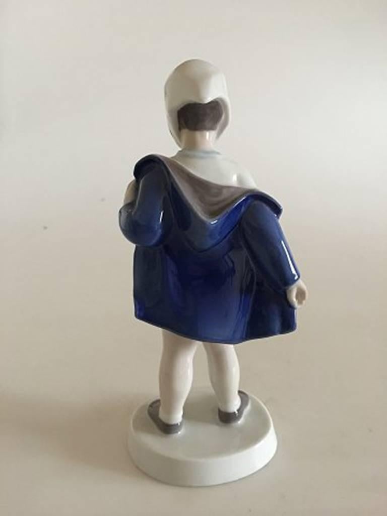 Bing & Grondahl figurine of girl off blue coat #2387. Measures 18.5cm / 7 1/4 in.