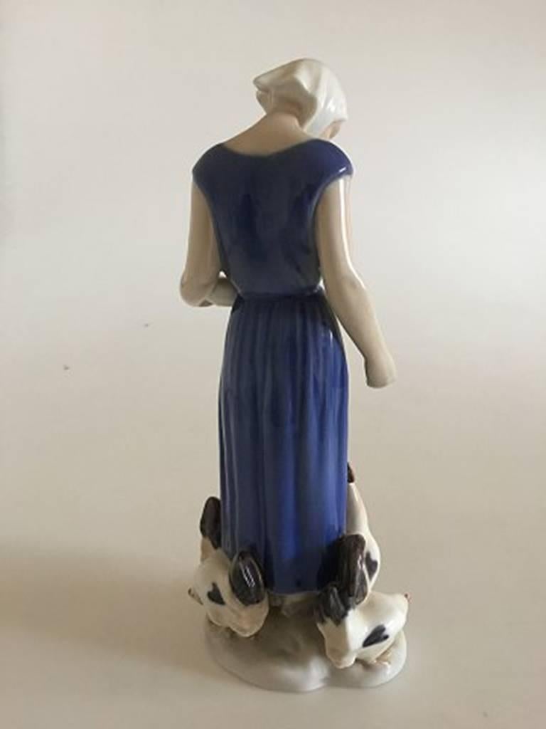 Bing & Grondahl figurine of woman feeding the chickens #2220. Designed by Axel Locher

Measures 23cm / 9 in.