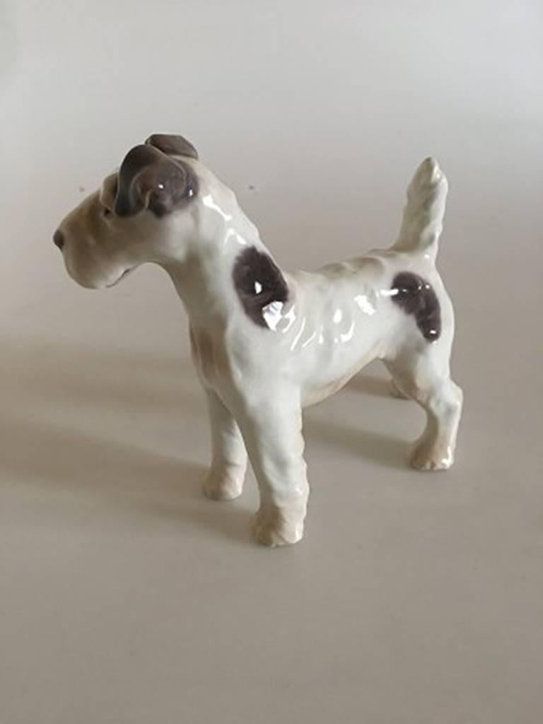 Bing & Grondahl figurine wire fox terrier #1998. Measures 17cm long and is in good condition. Designed by Dahl Jensen.