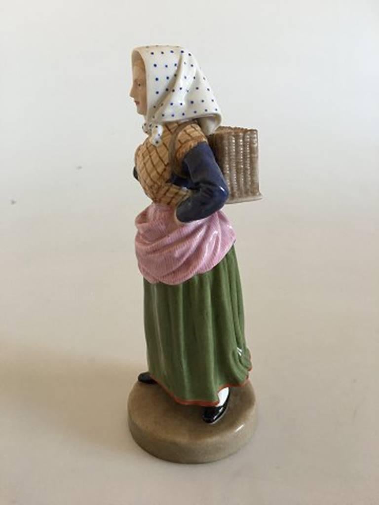 Bing & Grondahl overglaze figurine of lady. Measures 17.5cm and is in good condition.