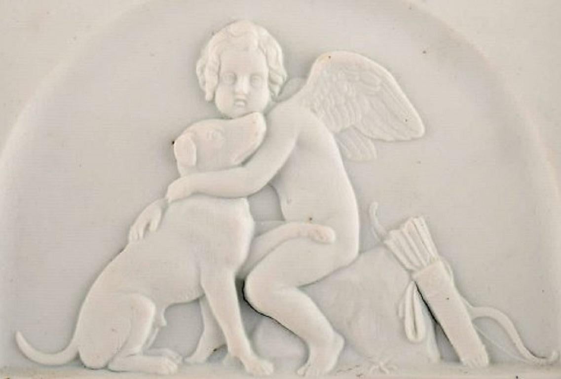 Bing and Grondahl after Thorvaldsen. Antique biscuit wall plaque. Cupid and a dog, late 19th century.
Measures: 12.5 x 9.5 cm.
Stamped.
In excellent condition.
1st factory quality.