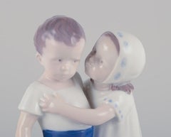 Bing and Grondahl, porcelain figurine of a little girl and boy.  Approx. 1930s