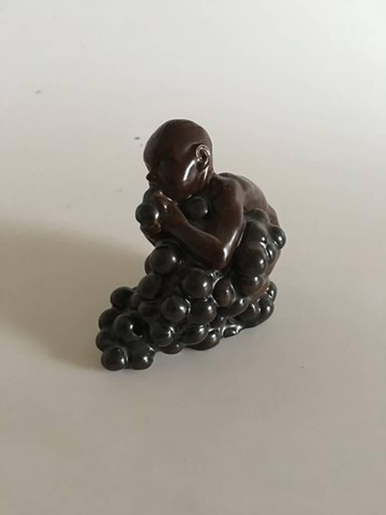 Bing and Grondahl stoneware figurine boy with grapes by Kai Nielsen #2. Measures: 10.5cm x 9.5cm and is in good condition.