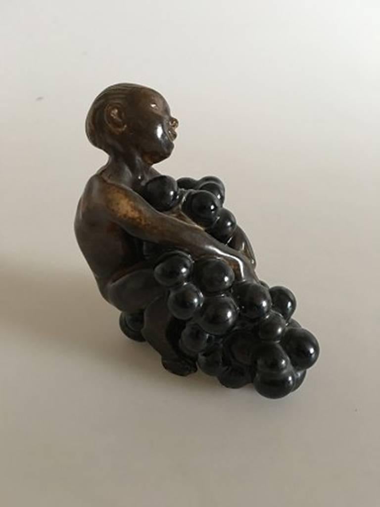 Bing & Grondahl stoneware figurine boy with grapes by Kai Nielsen. Measures 10.5cm x 9.5cm and is in perfect condition.