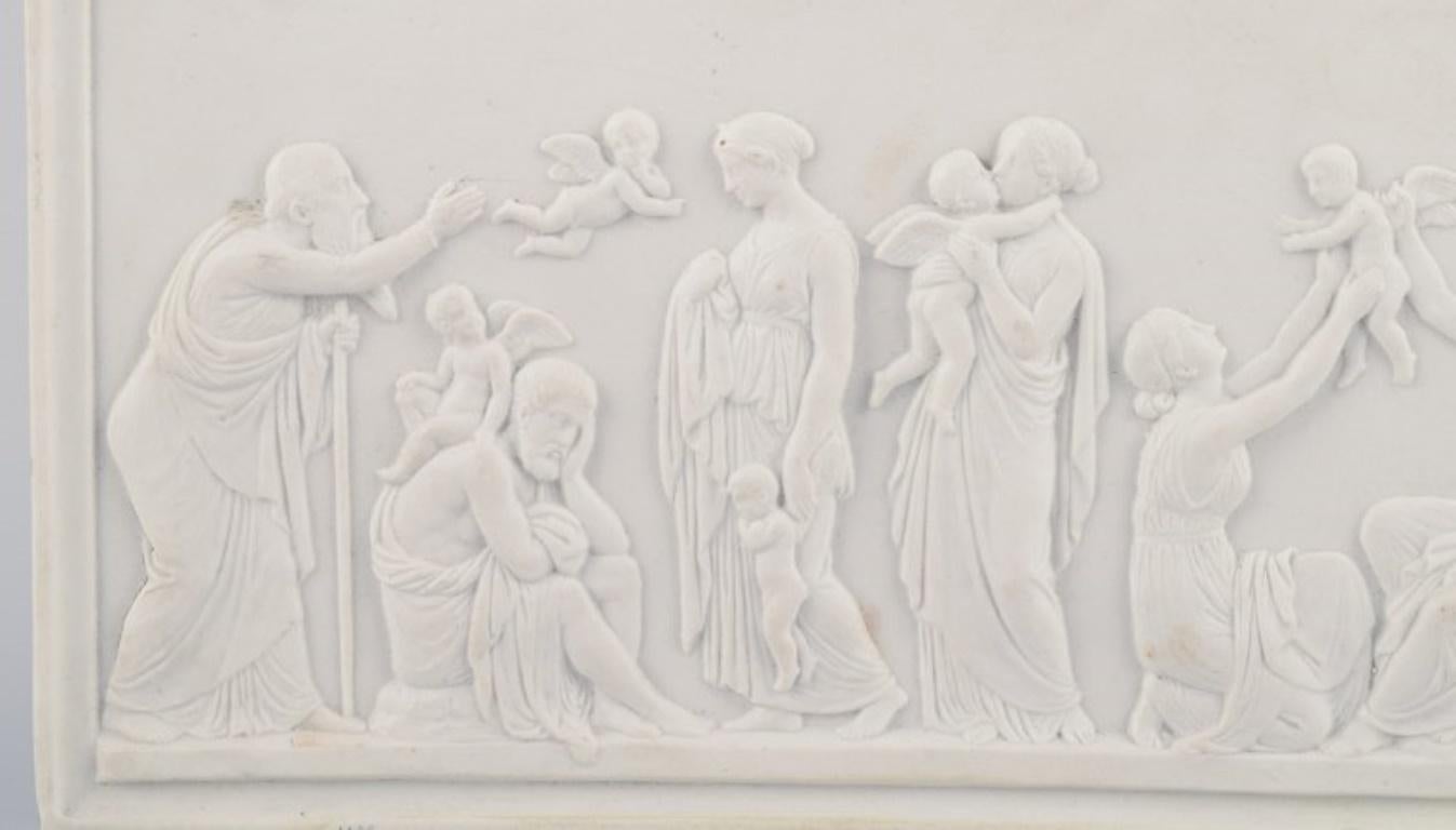 Bing & Grøndahl, biscuit relief after Thorvaldsen. 
'The Ages of Love' with winged Psyche, cupids, female and male figures.
Approximately from the 1870s.
In good condition, with an older and insignificant repair in the lower right