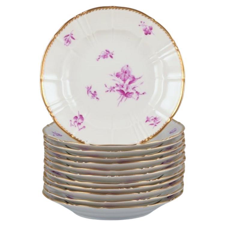 Bing & Grøndahl, Denmark. A set of twelve small plates with flower decorations For Sale