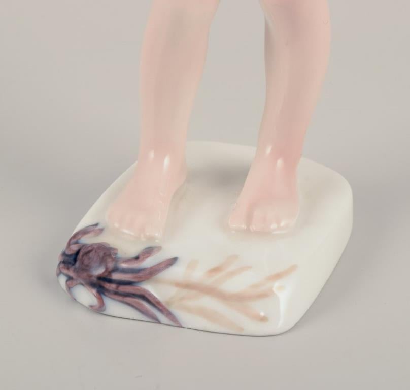 Glazed Bing & Grøndahl, Denmark. Porcelain figurine of a boy and crab. For Sale