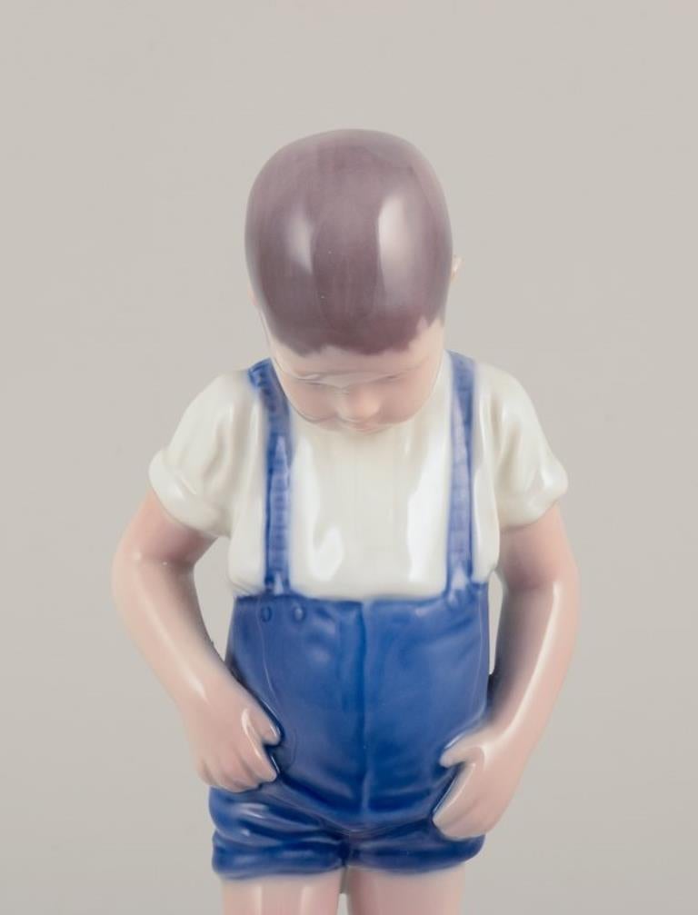 20th Century Bing & Grøndahl, Denmark. Porcelain figurine of a boy and crab. For Sale