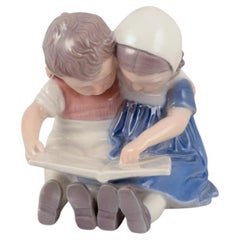 Bing & Grøndahl, Denmark. Porcelain figurine of reading children.