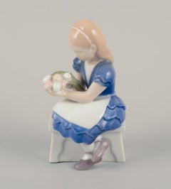 Bing & Grøndahl, Denmark. Porcelain figurine of seated girl with flowers.