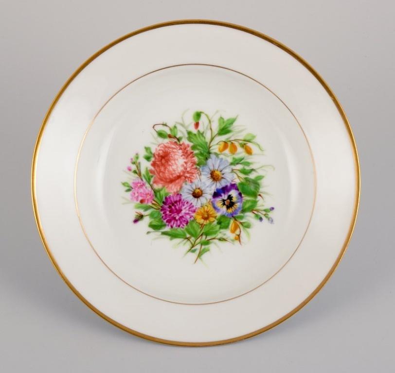 Danish Bing & Grøndahl, four deep plates in porcelain with flowers and gold decoration For Sale