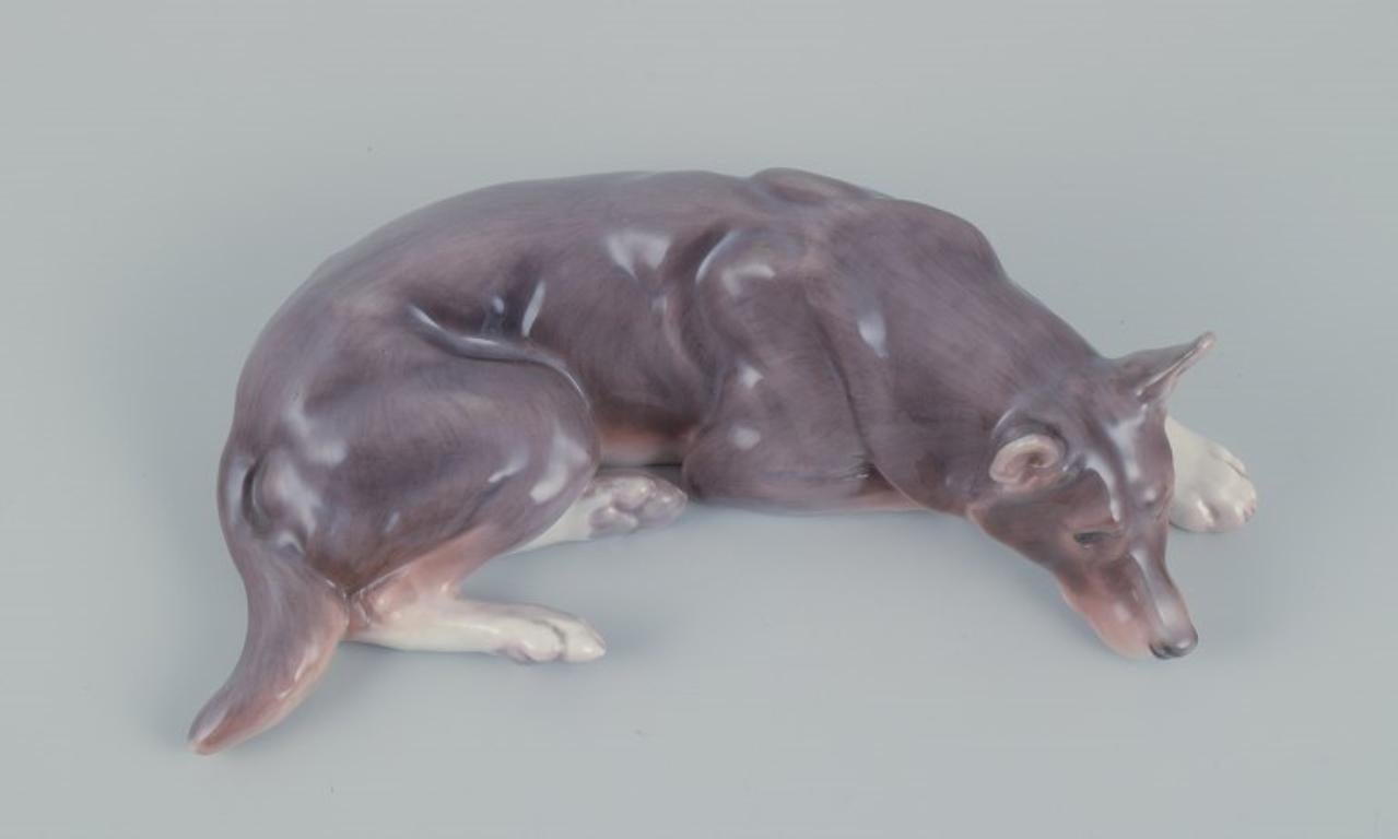 Danish Bing & Grøndahl porcelain figurine of a reclining German Shepherd.  For Sale