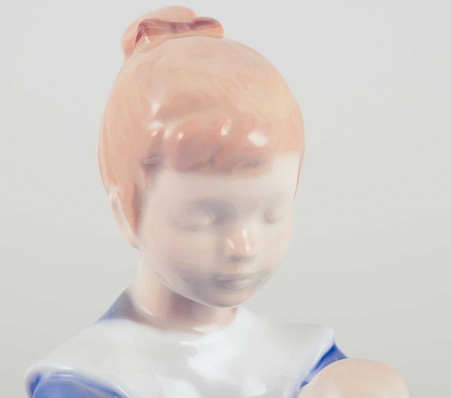 Late 20th Century Bing & Grøndahl porcelain figurine. Sitting girl tying a shoelace. For Sale