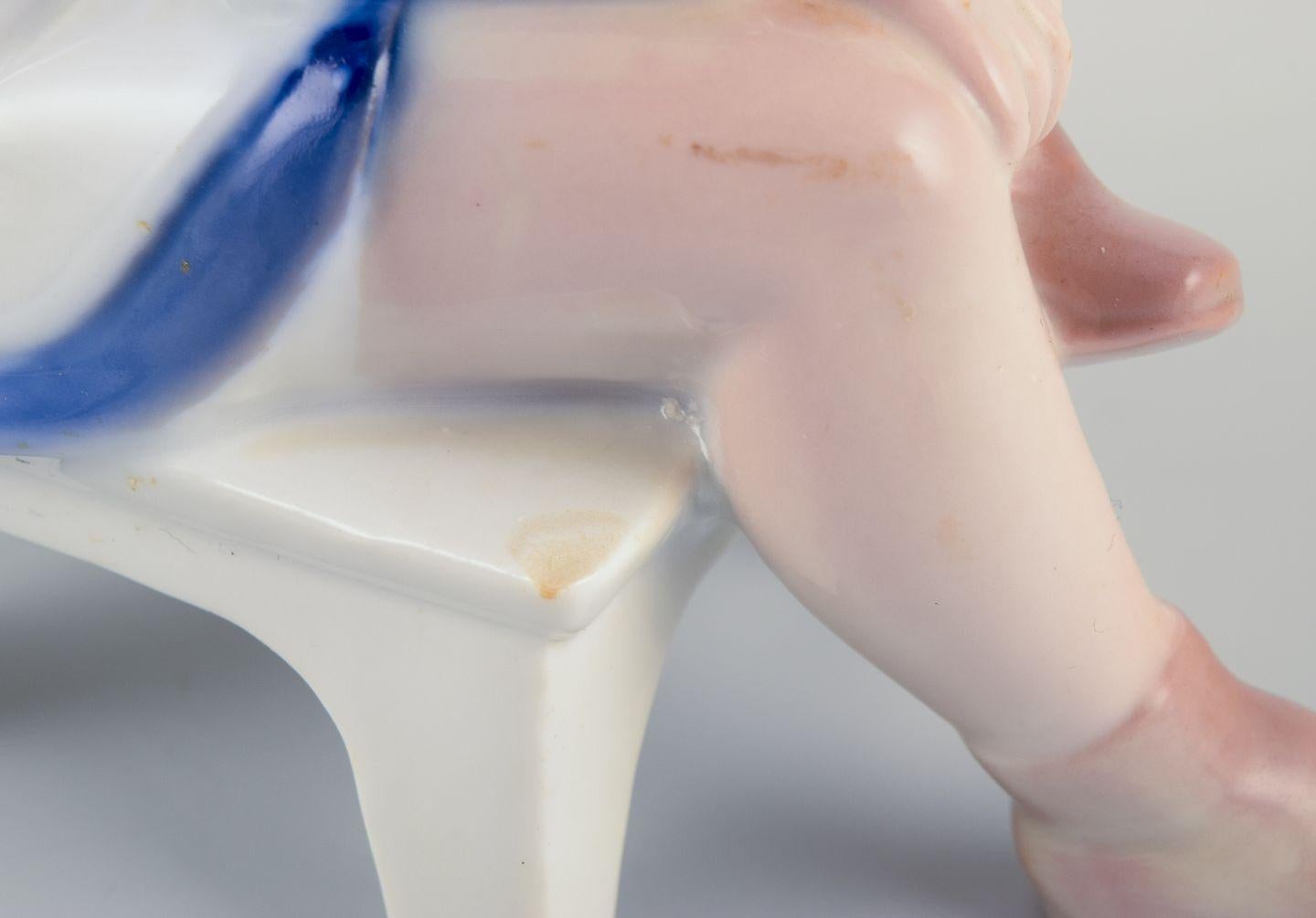 Bing & Grøndahl porcelain figurine. Sitting girl tying a shoelace. For Sale 1