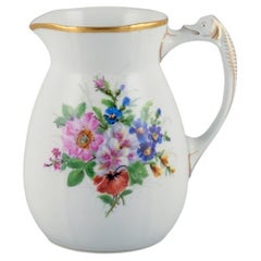 Bing & Grøndahl porcelain pitcher decorated with polychrome flowers.