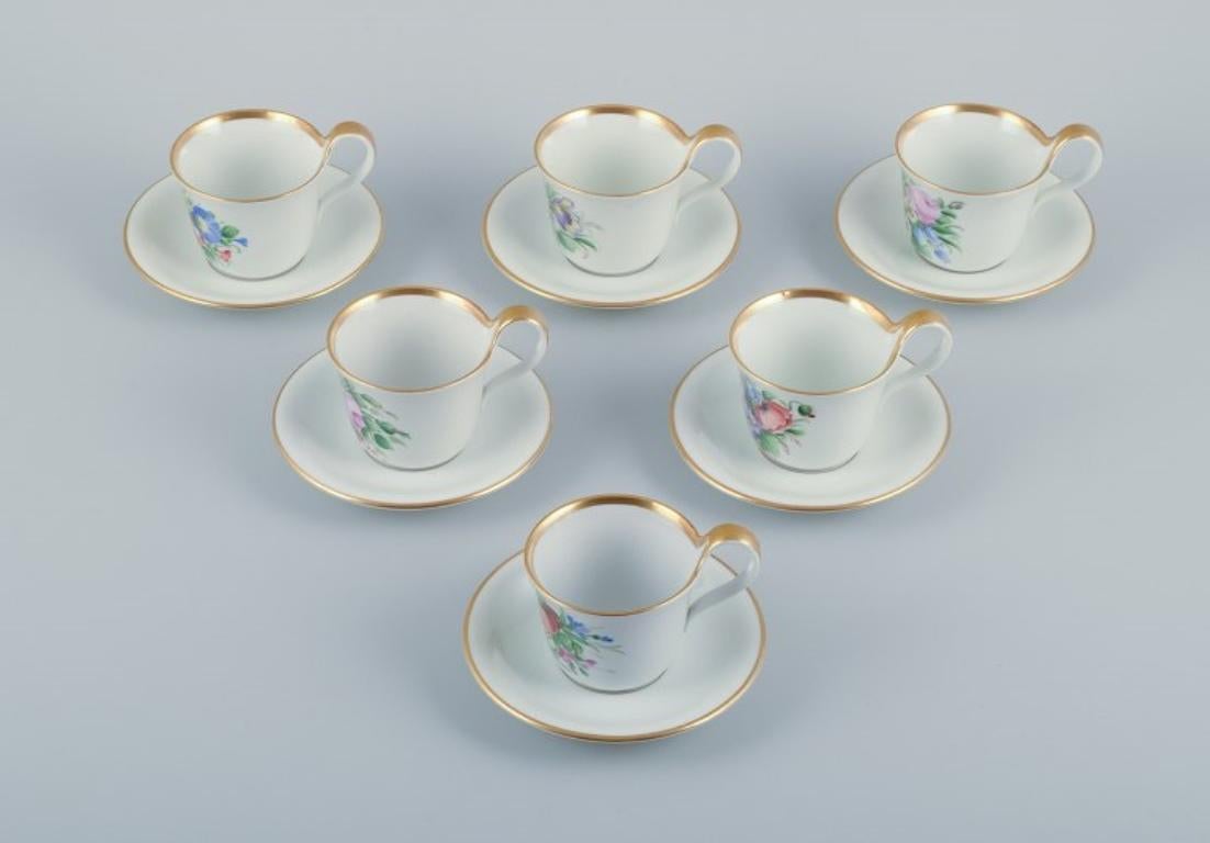 Bing & Grøndahl, a set of six antique coffee cups with high handles and  saucers. Hand-painted with polychrome flower decoration. 
Porcelain of heavy quality.
From the late 19th century.
In perfect condition.
First factory quality.
Marked.
Cup: