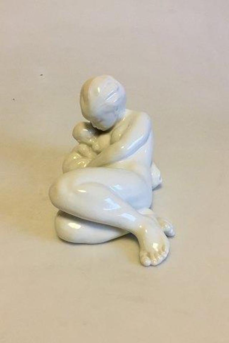 Bing & Grondahl Blanc de Chine Figurine of Woman with Child No 4029. Designed by Kai Nielsen. 

Measures 11 cm / 4 21/64 in. x 18 cm / 7 3/32 in.